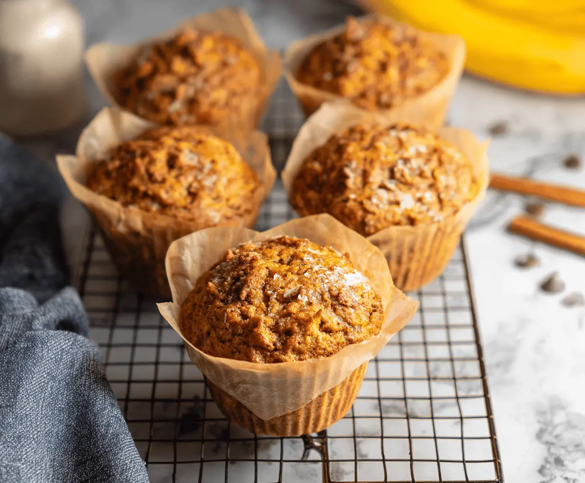 Delicious jumbo pumpkin banana muffins topped with cinnamon and nuts, perfect for fall breakfast or snack