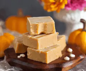 Creamy homemade pumpkin fudge topped with festive sprinkles, perfect for fall desserts.
