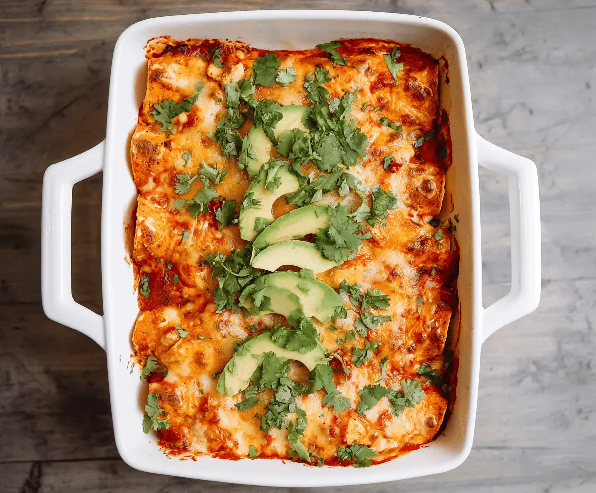 Delicious Sweet Potato Chicken Enchiladas topped with melted cheese and fresh cilantro on a serving plate