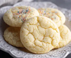 Delicious chewy drop sugar cookies with a golden-brown finish on a baking tray.