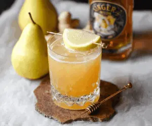 Frosted Ginger Pear Bourbon Cocktail with fresh pear and ginger garnishes