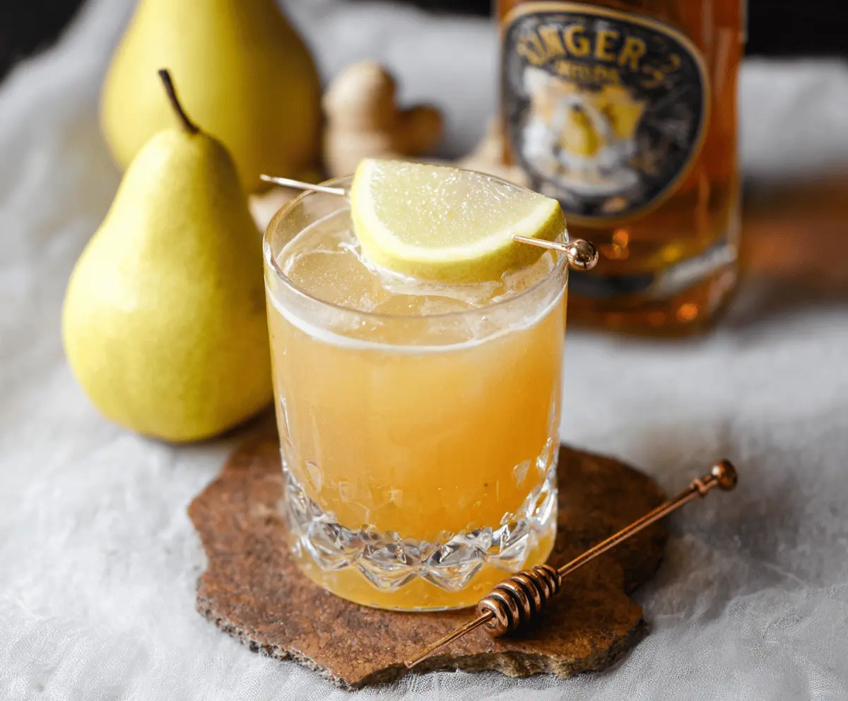 Frosted Ginger Pear Bourbon Cocktail with fresh pear and ginger garnishes