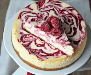 Delicious White Chocolate Raspberry Swirl Cheesecake with a creamy texture and vibrant berry swirl.