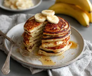Delicious banana yogurt pancakes topped with fresh fruit for a healthy breakfast.
