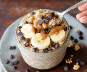 Delicious Chunky Monkey Overnight Oats with bananas, walnuts, and chocolate chips in a glass jar