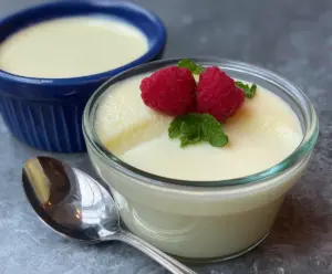 Creamy egg white pudding topped with fresh berries and mint for a healthy dessert