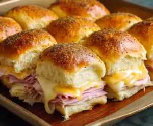 Delicious ham and cheese sliders served on a platter, perfect for appetizers and snacks.