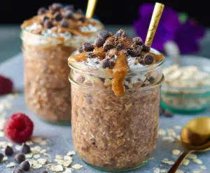 Creamy mocha overnight oats in a jar topped with chocolate shavings and a drizzle of syrup, perfect for a healthy breakfast.