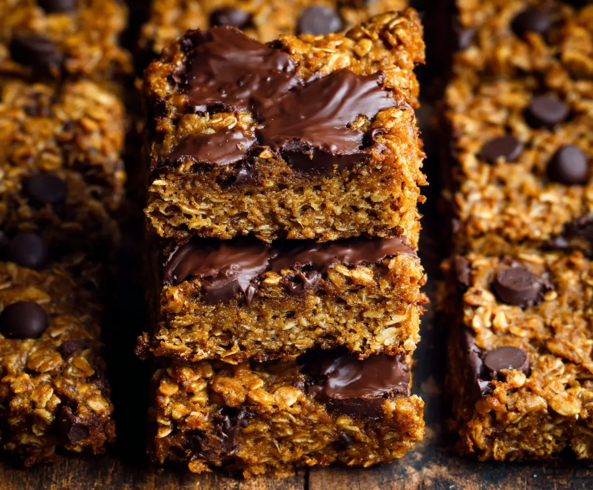 Delicious homemade Pumpkin Oatmeal Bars with cinnamon and nutmeg on a rustic wooden background