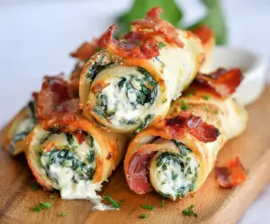 Delicious spinach and bacon cream cheese roll ups on a platter, perfect for appetizers.