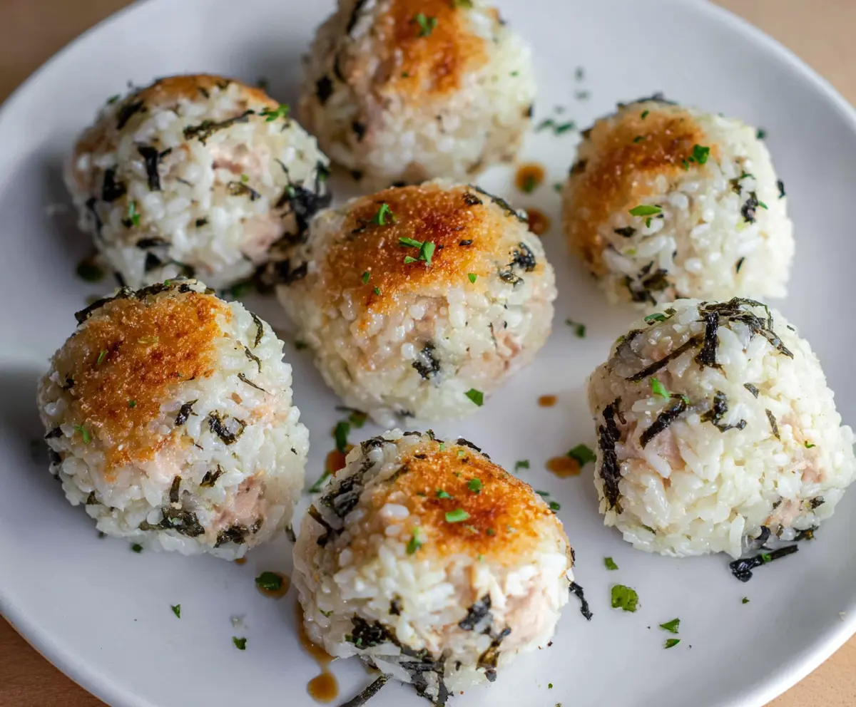 Delicious homemade tuna rice balls with savory filling and sesame garnish