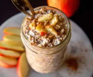 Delicious apple cinnamon protein overnight oats in a glass jar, healthy breakfast idea