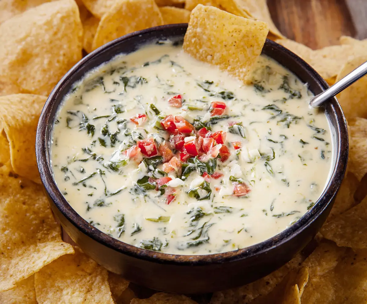 Creamy White Spinach Queso served with crispy chips, perfect for sharing at Chili's.