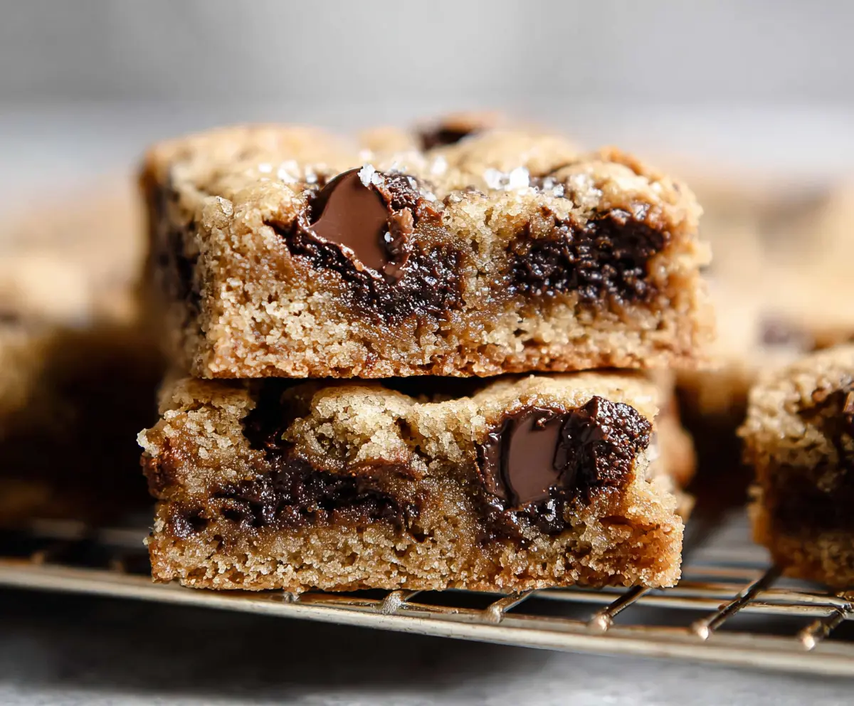 Delicious chocolate chip sourdough cookie bars on a plate, showcasing a gooey, baked dessert with chocolate chunks.