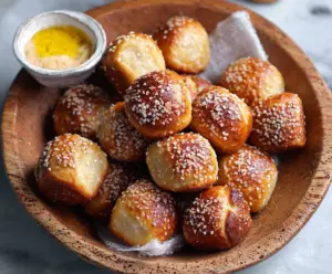Delicious yeast-free sourdough discard pretzel bites on a rustic wooden table, ready to serve.