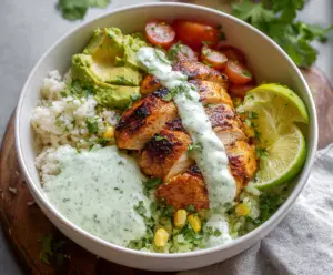 Fresh cilantro lime chicken bowls with colorful vegetables and a zesty lime garnish