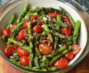 Fresh balsamic asparagus and tomato salad in a white bowl, highlighting vibrant vegetables and a drizzle of balsamic glaze.