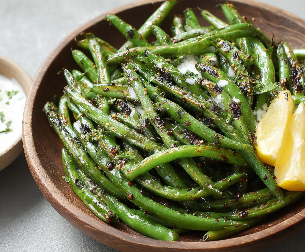 Delicious blackened green beans garnished with herbs, perfect for a healthy side dish.