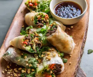 Fresh Thai Beef Spring Rolls wrapped in rice paper with vibrant herbs and vegetables