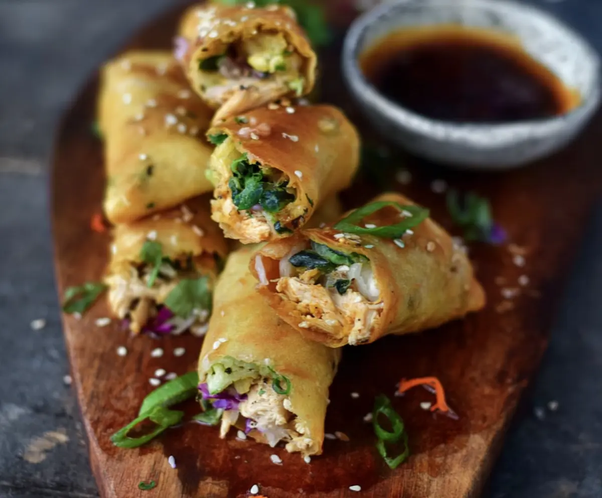 Delicious turmeric sesame chicken spring rolls with fresh vegetables and herbs